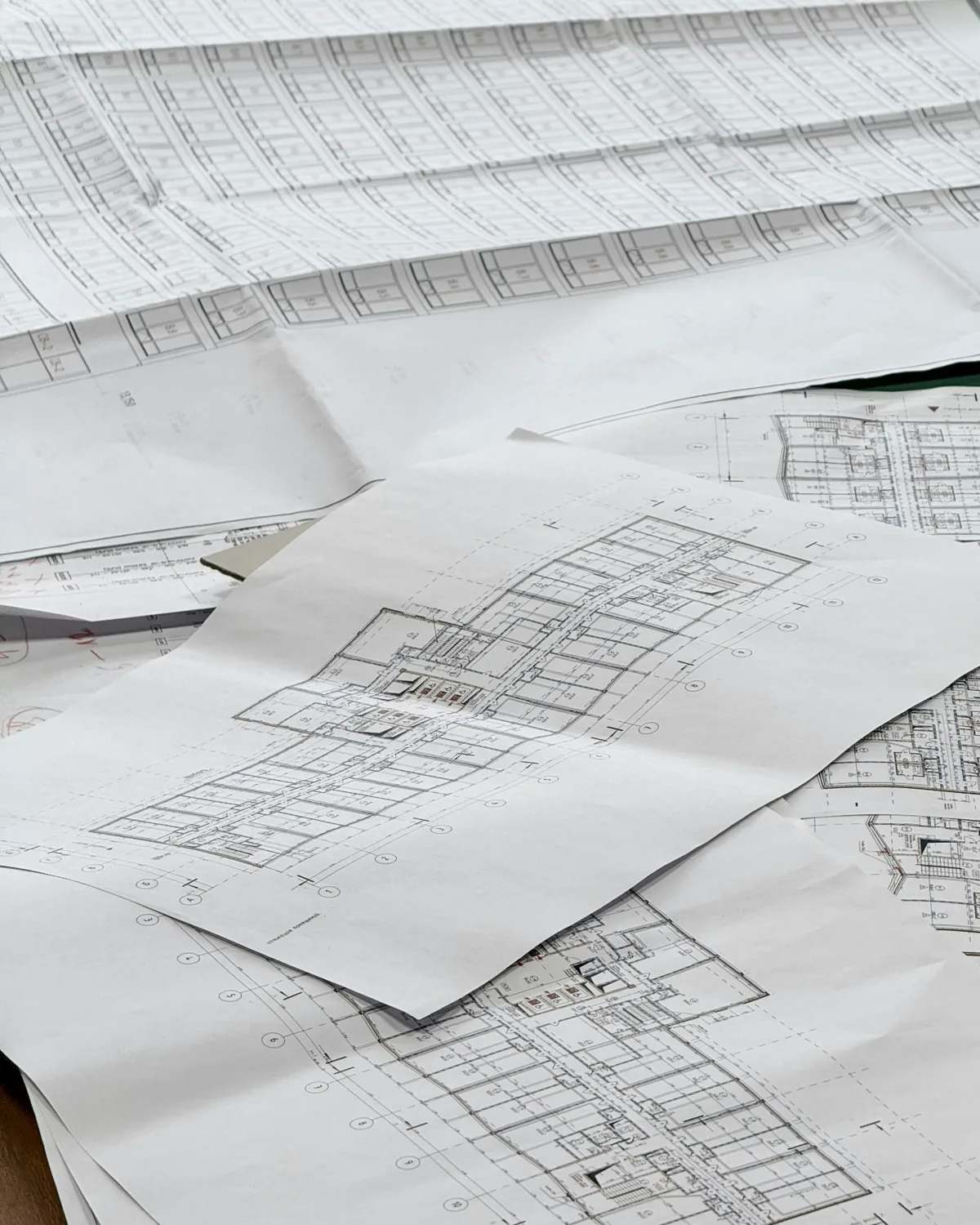 Architectural floor plans arranged on a work surface